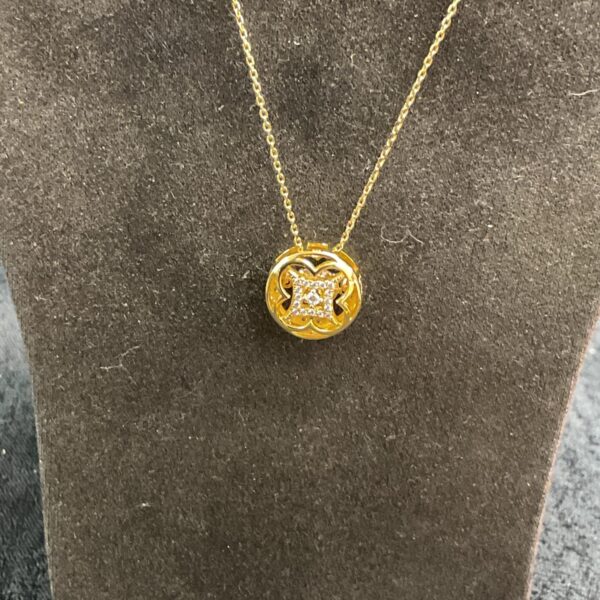 Pandora silver gilt necklace with white stone pendant detail.