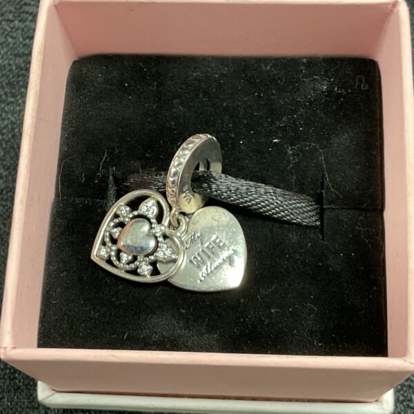 Silver Pandora wife charm with heart engraving.