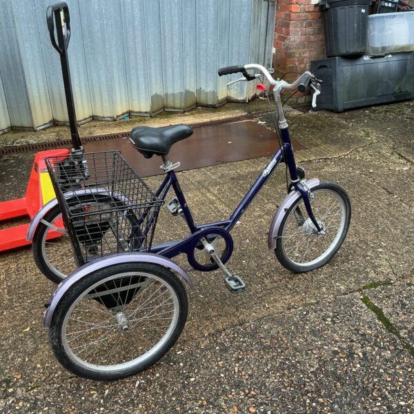 Front view of a vintage Pashley tricycle with a basket.