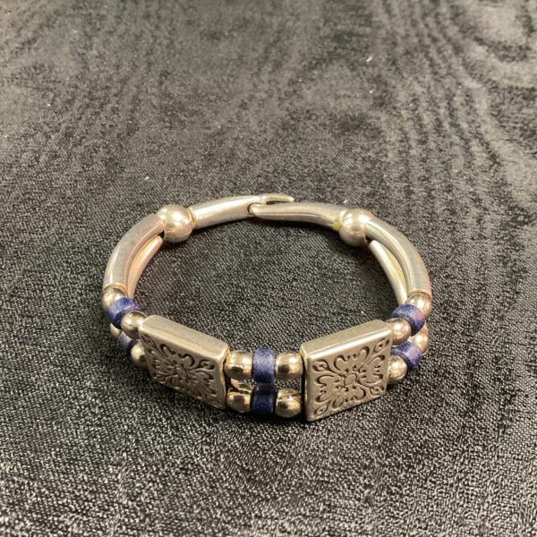 Vintage Persian silver bangle with blue accents and hook clasp.
