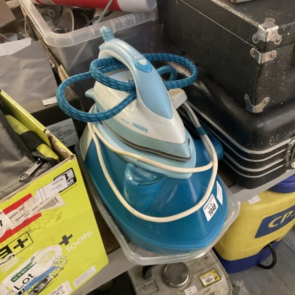 Close-up of a vintage Philips steam iron with water tank.