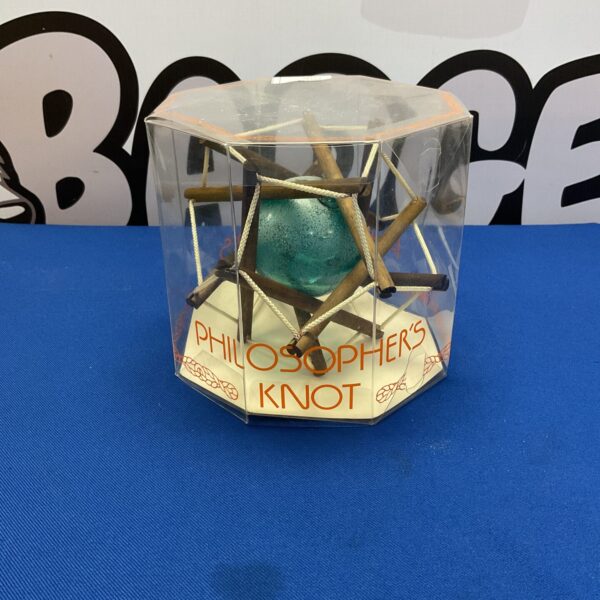 Front view of a Philosophers Knot sculpture with a green sphere.