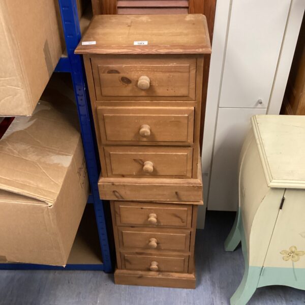 Vintage pine bedside cabinet with three drawers for bedroom storage.