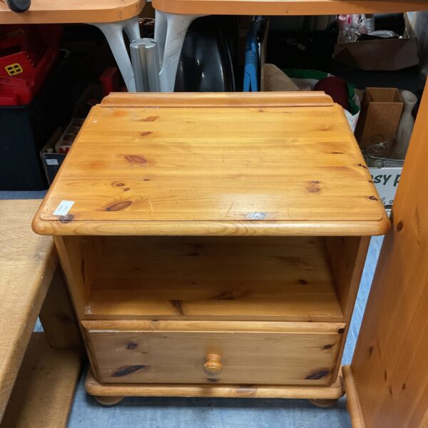 Rustic pine bedside cabinet with a single drawer for bedroom storage.