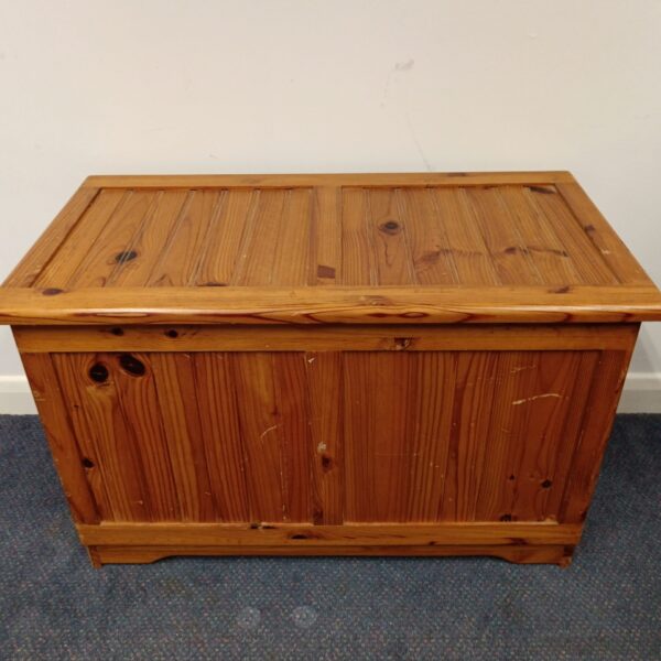 Front view of a rustic pine blanket box.