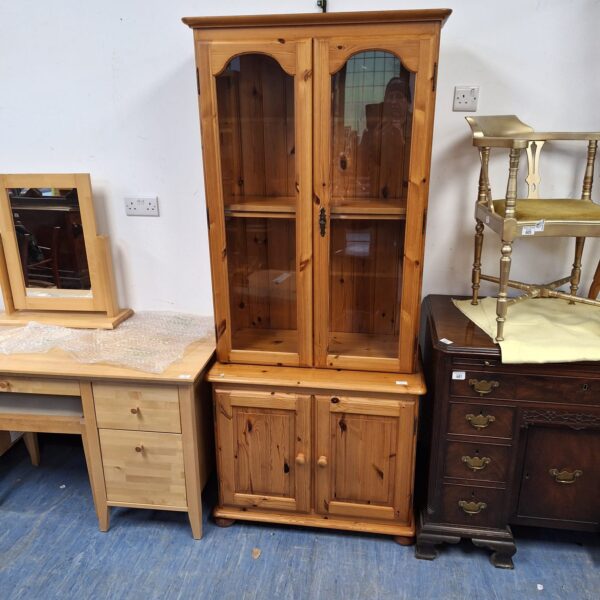 Vintage pine display cabinet with glass front for collectibles.