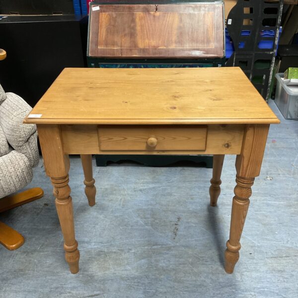 Small pine side table with drawer and turned legs.