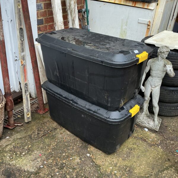Lot of two plastic storage boxes for household organisation.