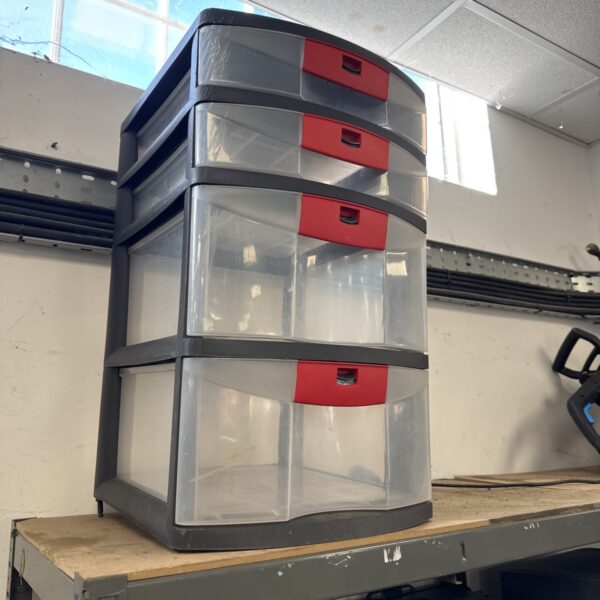 Compact plastic storage cabinet with four clear drawers.