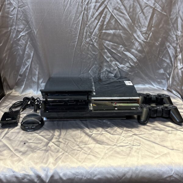 Sony PlayStation 3 console with two controllers and charging dock.