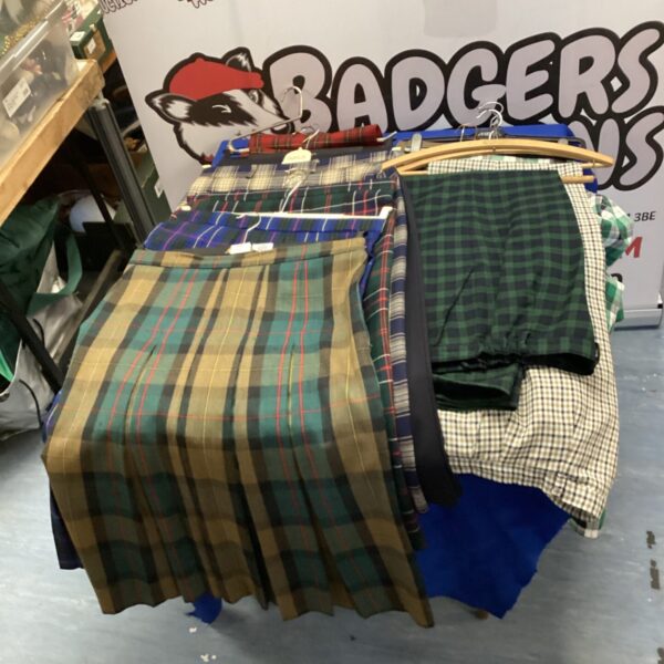Large bundle of chequered and pleated skirts for sale.