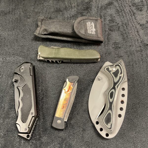 Lot of four pocket knives with varied designs and handles.
