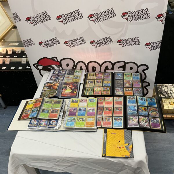 Pokemon card collection displayed on a table with binders.