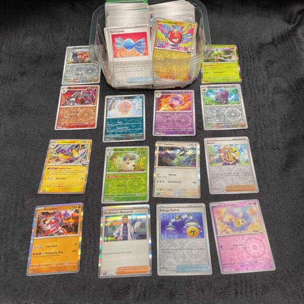 Sorted Pokémon card lot with shiny and holographic cards.