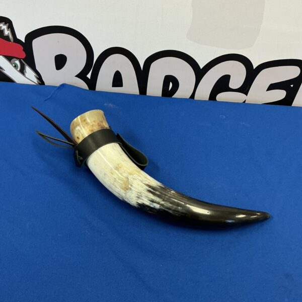Polished horn with dark cord, ideal for tribal or rustic decor.