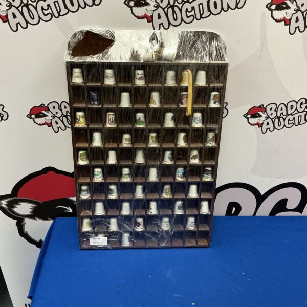 Vintage porcelain thimble collection on display stand.