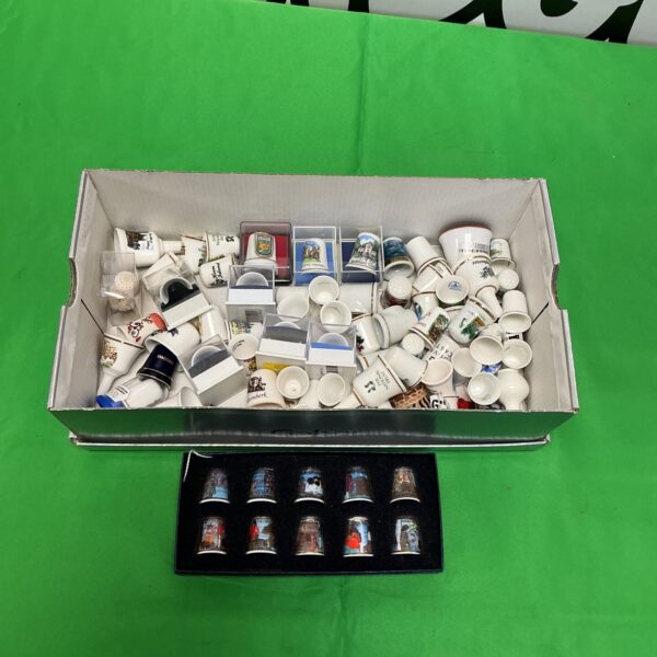 Collection of vintage porcelain thimbles for collectors and sewing enthusiasts.