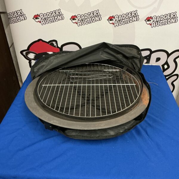 Black portable barbecue grill with carry case open.