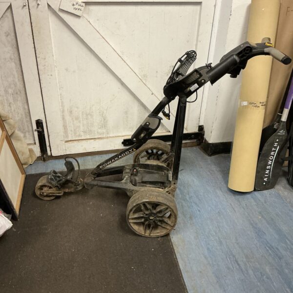 Side view of a used Power Caddy golf cart.