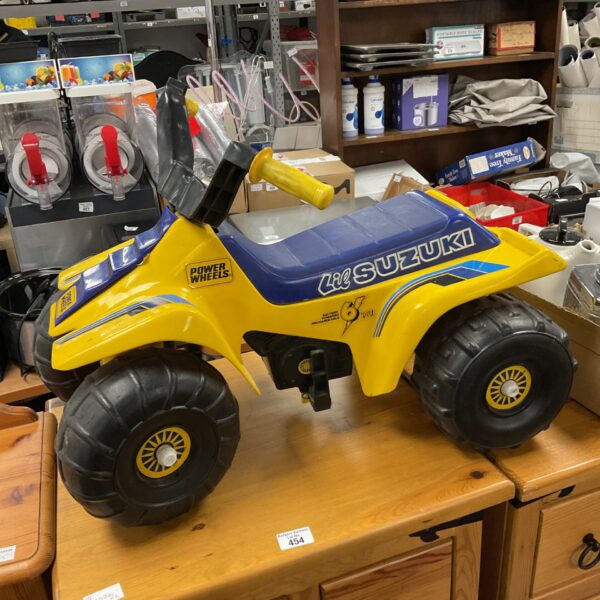 Yellow Power Wheels Lil Suzuki quad bike ride on toy.
