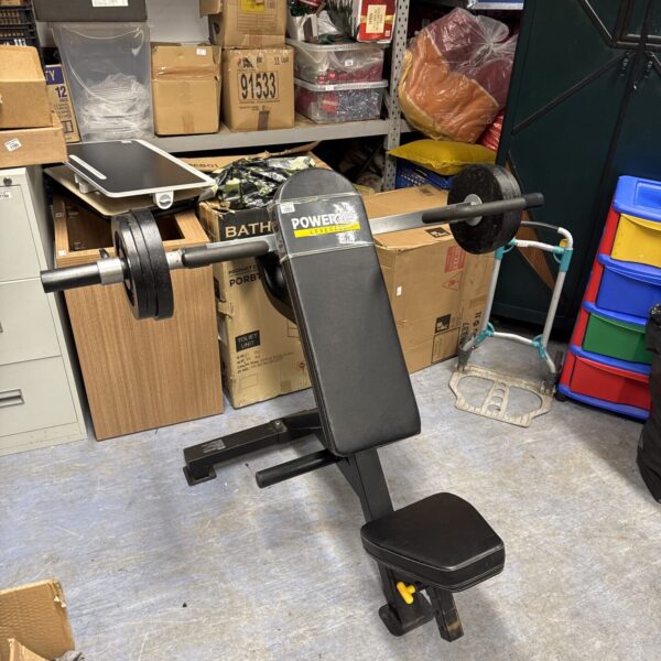 Powertec leverage chest press machine in a garage setting.