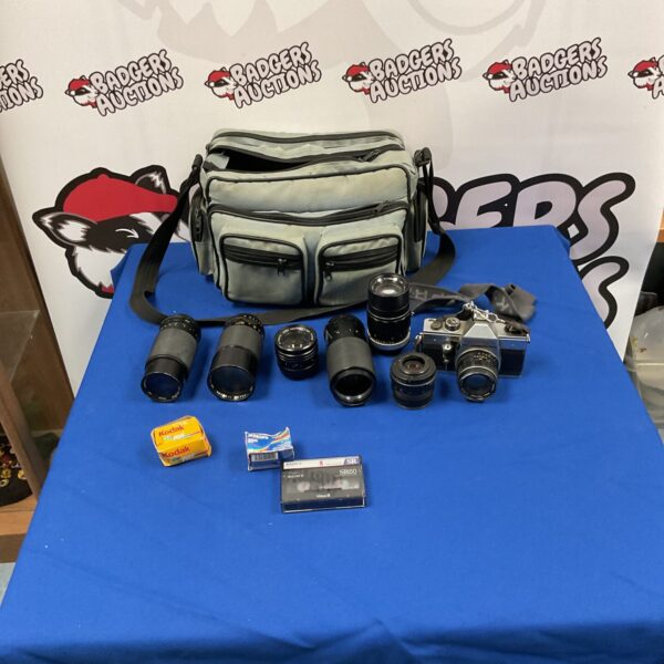 Vintage Praktica MTL 5 B camera kit with lenses and bag.