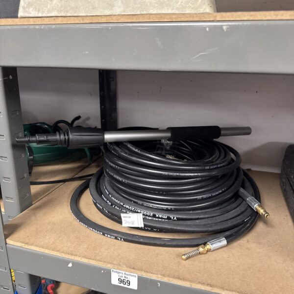 Black pressure washer hose with lance attachment section.