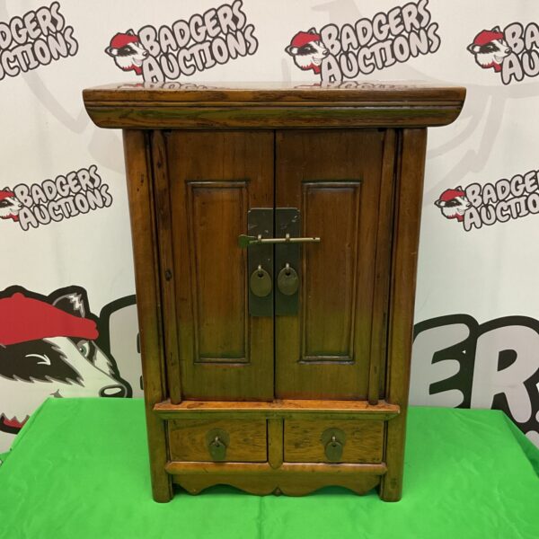 Antique Qing Dynasty apothecary cabinet with dark wood finish.