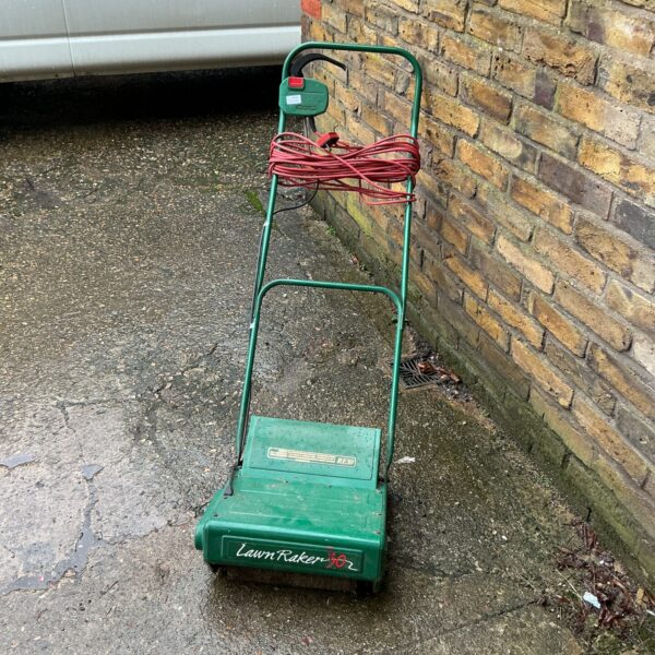 Vintage Qualcast electric lawn spiker for garden aeration.