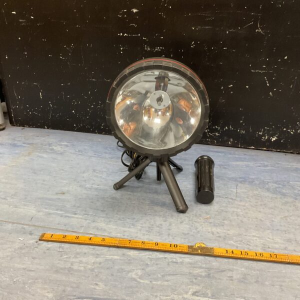 Vintage quartz halogen spotlight mounted on a tripod.