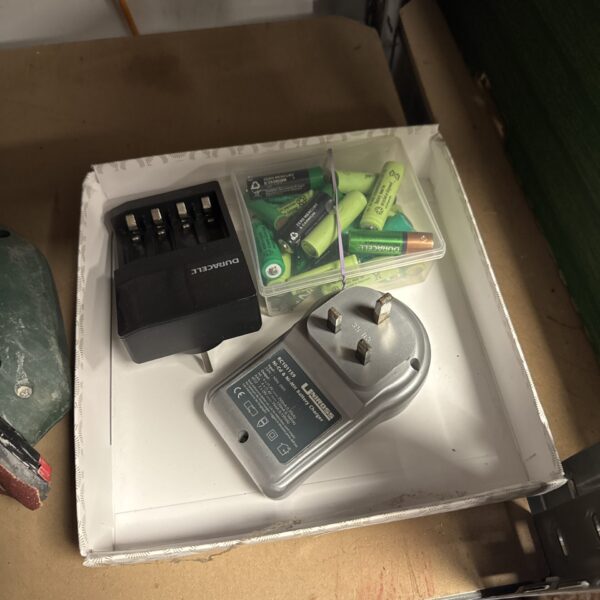 Vintage rechargeable battery set with charger and AA batteries.