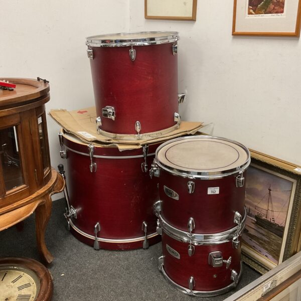 Red Mapex drum kit drums in auction setting.