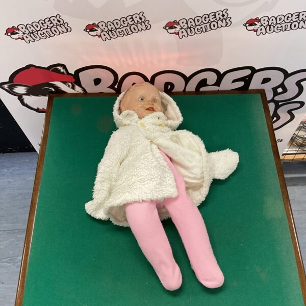 Vintage Reliable Doll in pink and patterned clothing.
