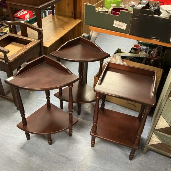 Three reproduction darkwood tiered units for display.