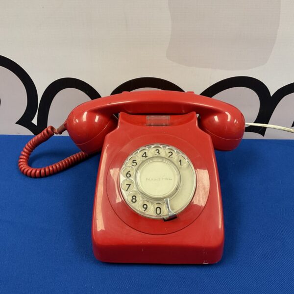 Vintage red British Telecom rotary dial telephone.