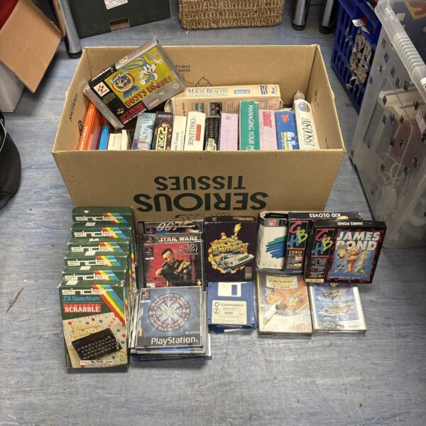 Box of retro video games including Sinclair, Nintendo and PC titles.