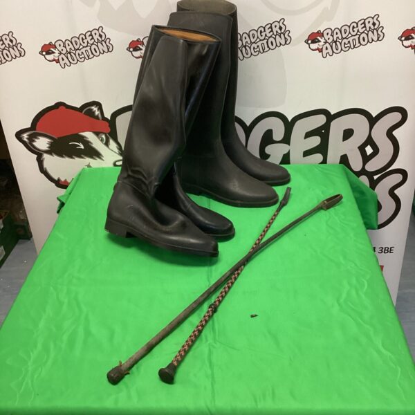 Vintage equestrian set with riding boots and crops.