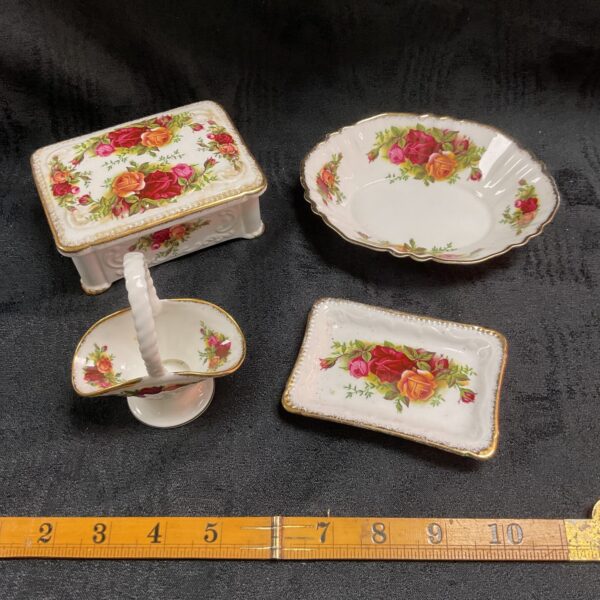 Royal Albert China collection featuring a floral basket and trinket box.