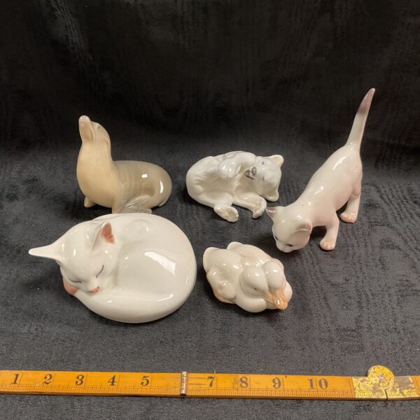 Royal Copenhagen porcelain animal figurines, including polar bear and cats.