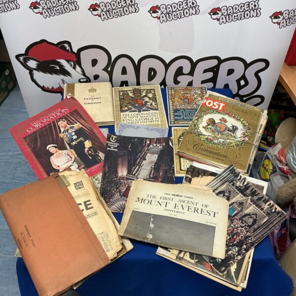 Vintage collection of royal event newspapers and programmes.