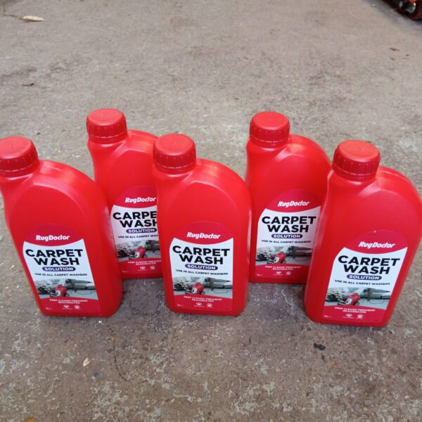 Five bottles of Rug Doctor carpet wash solution for cleaning.