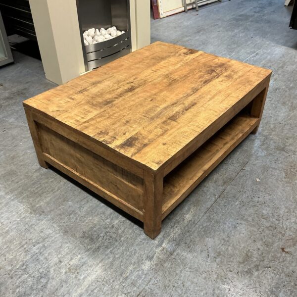 Rustic wooden coffee table with lower shelf for storage.