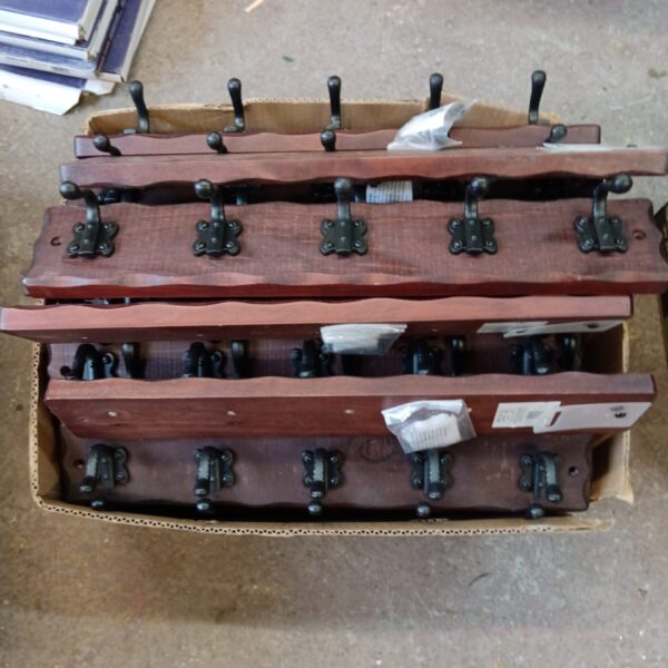 Rustic Tudor style coat rack with five hooks for coats and hats.