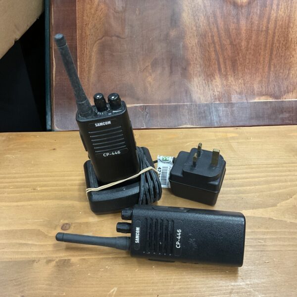 Samcom CP-446 walkie talkies with charger base, handheld radios.