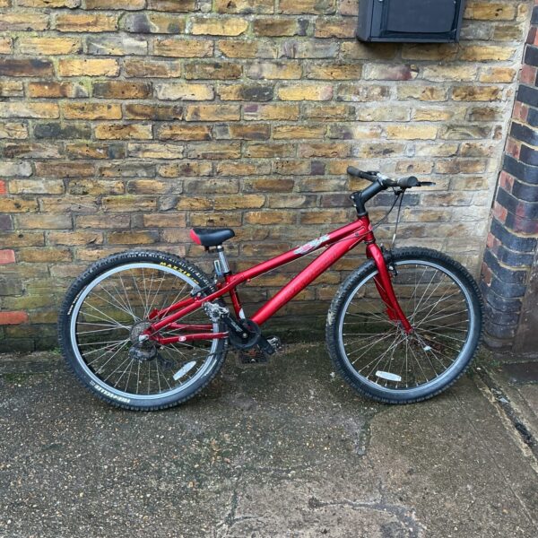 Red vintage Saracen mountain bike in used condition.