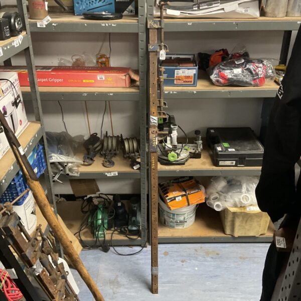Bundle of three metal sash clamps and one rail.