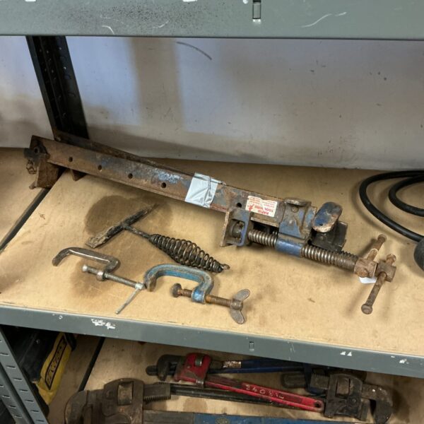 Vintage metal sash clamps and G clamps for woodworking projects.