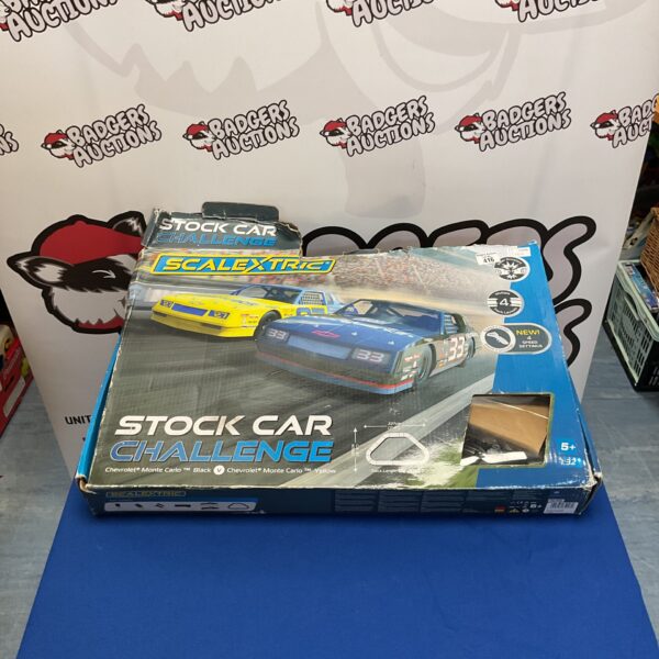 Scalextric stock car Chevrolet Monte Carlo in black and yellow packaging.