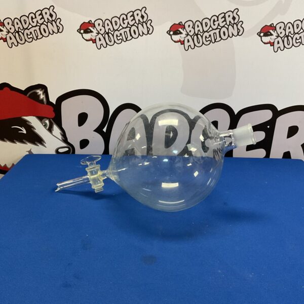 Clear glass scientific sphere on acrylic stand for display.