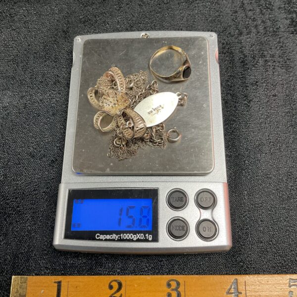 Close-up of 15.8g scrap silver jewellery lot for repair or crafting.